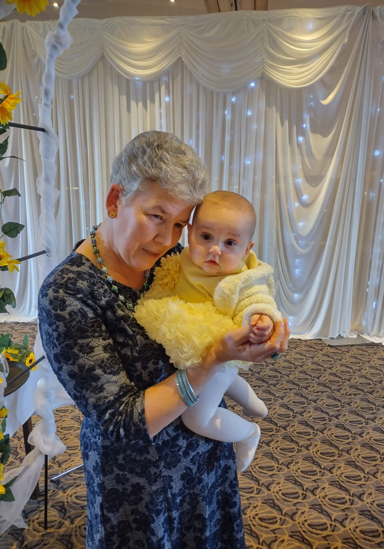 Kerry with baby, at naming event.